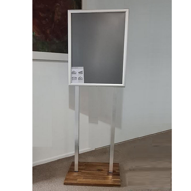 Double Sided Snap Frame Display Anodized Silver A2 Poster Stand on Hardwood Base. 2 x 25mm Profile Snap Frames Anodized Silver Takes Poster Size A2 Portrait format 420mm wide x 594mm high with visible area 411mm w x 585mm h Assembled height 1520mm to top of frame Snap Frames Supplied with Clear PVC Poster Cover Sheets Square 30mm Metal, uprights Natural Anodized Silver Hardwood Base 460mm w x 350mm d with 4 non slip rubber pad feet