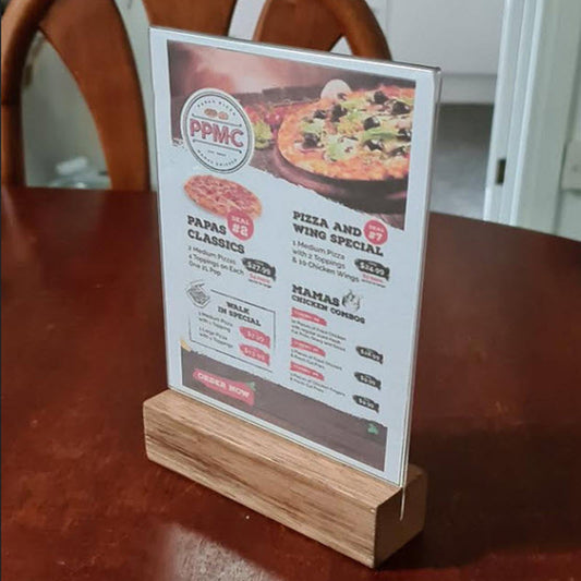 A5 menu table talker on wood base Widely Used Within Hospitality Industry  Table Talkers, Menu and other Display/ Information Holders  A5 Portrait Acrylic Sleeve Display Panel on Hardwood Base  Provides Full Double Sized Viewing of A5 above the Base  Sleeve Design Opens to Allow Displays to be Easily Inserted  Suitable for  A5 Size Portrait sheets each 148mm w x 210mm high  Durable Design High Impact Clear Acrylic.  Acrylic Secured into Base.