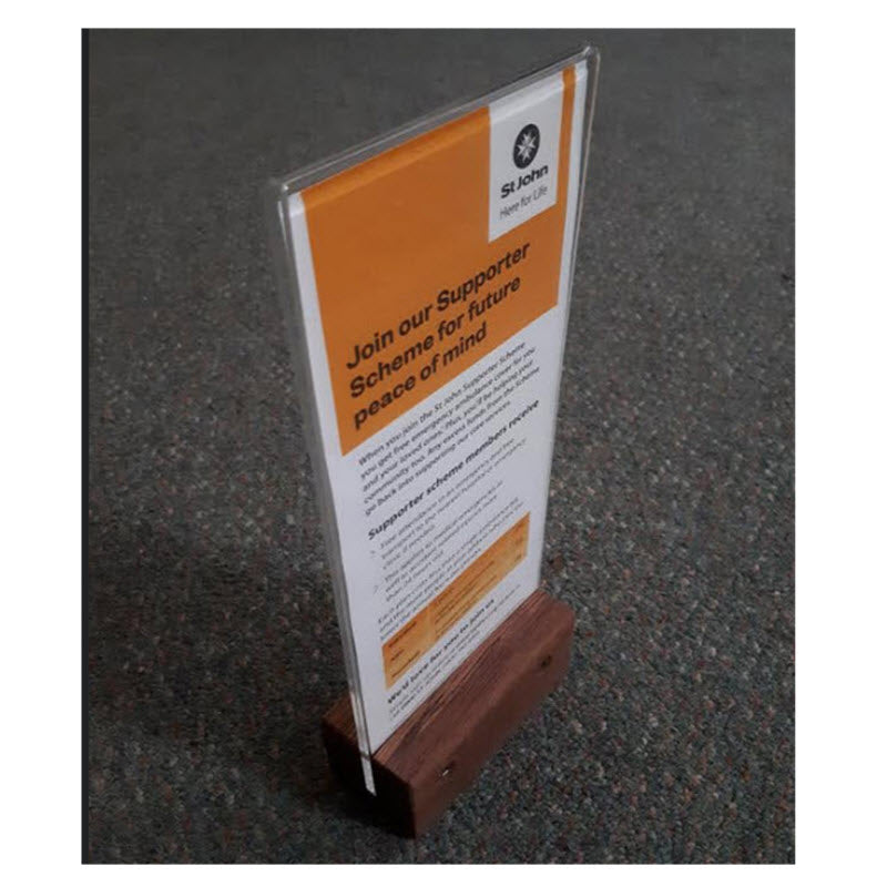 Widely Used Within Hospitality Industry As Table Talkers, Menu and other Display/ Information Holders DLE Acrylic Sleeve Display Panel on Hardwood Base Provides Full Double Sized Viewing of DLE above the Base Sleeve Design Opens to Allow Displays to be Easily Inserted Suitable for DLE Size Portrait sheets each 103mm w x 210mm high Durable Design High Impact Clear Acrylic. Acrylic Secured into Base. Allows Displays to be Protected from Dust and Spills, Easily Cleaned