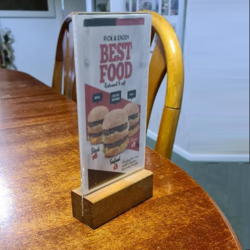 Widely Used Within Hospitality Industry As Table Talkers, Menu and other Display/ Information Holders DLE Acrylic Sleeve Display Panel on Hardwood Base Provides Full Double Sized Viewing of DLE above the Base Sleeve Design Opens to Allow Displays to be Easily Inserted Suitable for DLE Size Portrait sheets each 103mm w x 210mm high Durable Design High Impact Clear Acrylic. Acrylic Secured into Base. Allows Displays to be Protected from Dust and Spills, Easily Cleaned