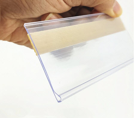 Pack of 25 x Quantity, 80mm x 26mm Clear Label Holders Flat Clear PVC Ticket Strip Self Adhesive Ticket / Label Holders Affix to Shelf Edge, or to Flat Face of Cupboards/ Lockers etc. Forms a Protective Ticket Display Holder 80mm wide to hold paper 26mm high Can be used to holder higher tickets standing upright Paper Ticket / Display easily inserted and changed as required.