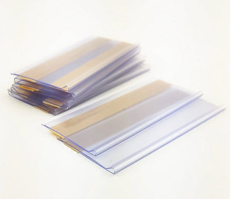 Pack of 25 x Quantity, 80mm x 26mm Clear Label Holders Flat Clear PVC Ticket Strip Self Adhesive Ticket / Label Holders Affix to Shelf Edge, or to Flat Face of Cupboards/ Lockers etc. Forms a Protective Ticket Display Holder 80mm wide to hold paper 26mm high Can be used to holder higher tickets standing upright Paper Ticket / Display easily inserted and changed as required.